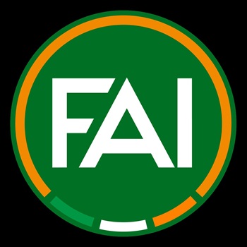 FAI Logo - FAI written in while with a green background with an orange circumference and green, white and orange at the bottom of the circle.